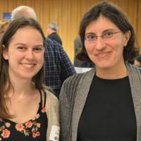 Two alumnae pose for a photo at the Academic Major Fair.